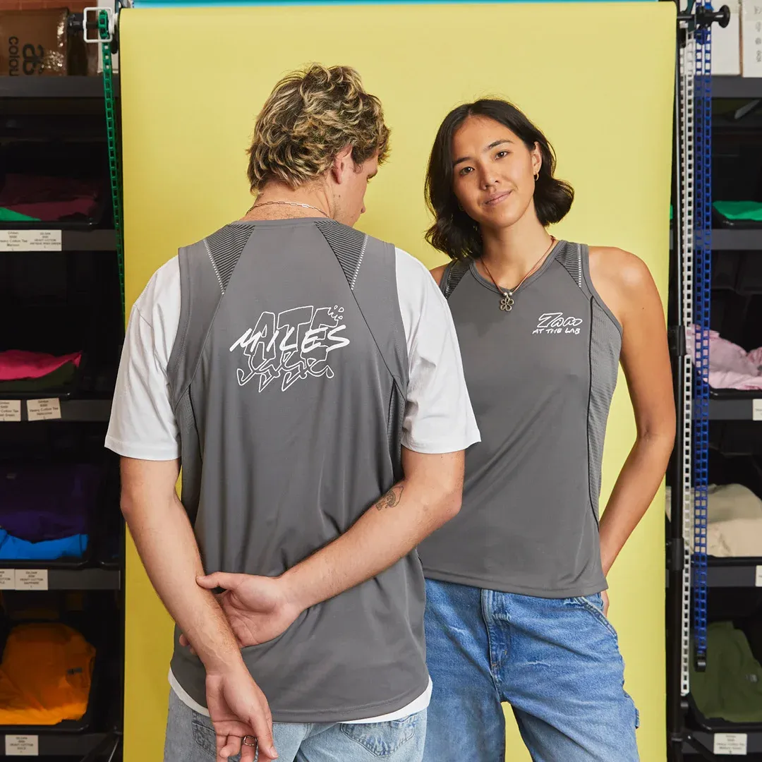 Two people are wearing custom sportswear tank tops for a run club