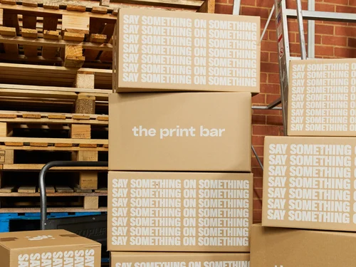 A group of sustainable packaging boxes are stacked and ready to be delivered Australia wide or internationally from The Print Bar