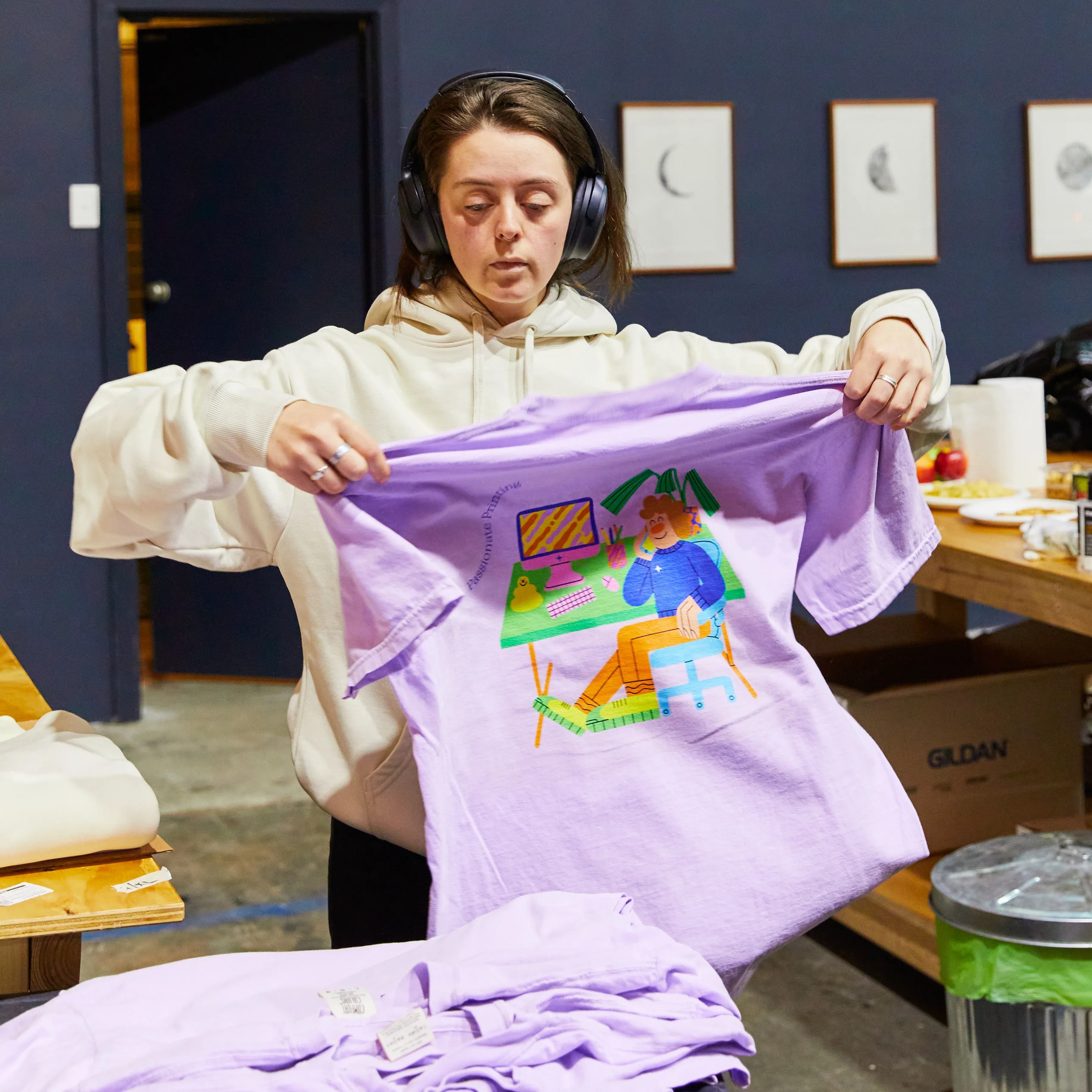 A person in The Print Bar's Melbourne location is folding a personalised t-shirt