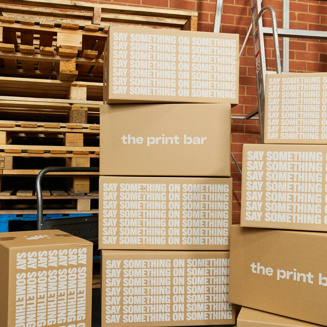 A group of sustainable packaging boxes are stacked and ready to be delivered Australia wide or internationally from The Print Bar