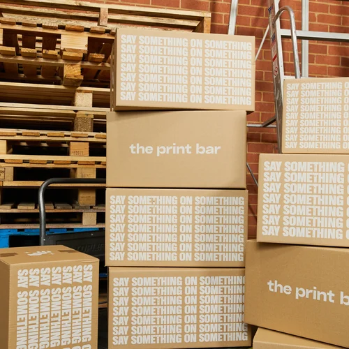 A group of sustainable packaging boxes are stacked and ready to be delivered Australia wide or internationally from The Print Bar