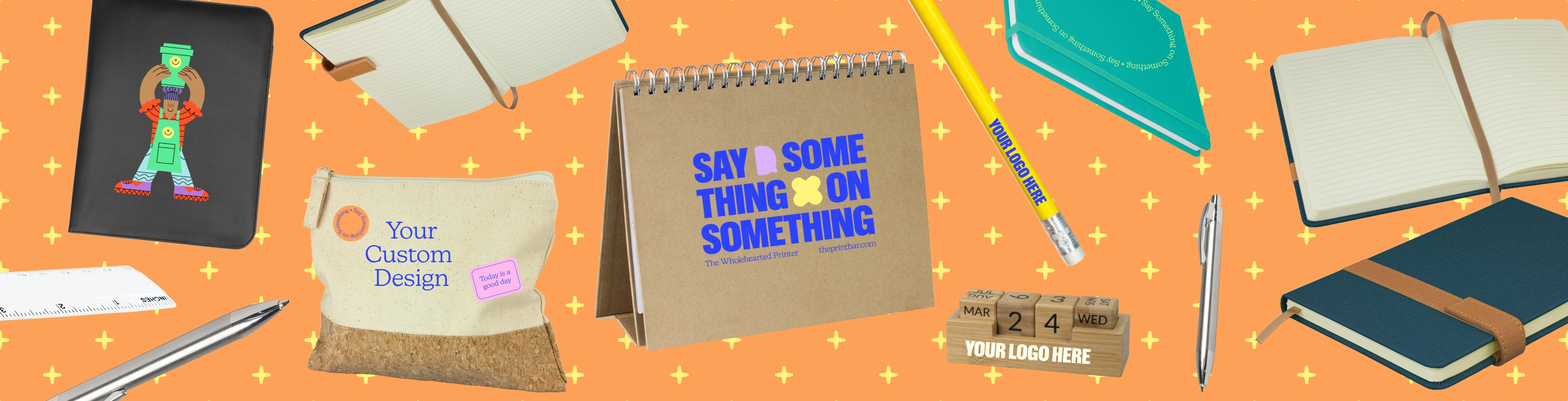 Image with custom pens and pencils that have the text "design your own" printed on them