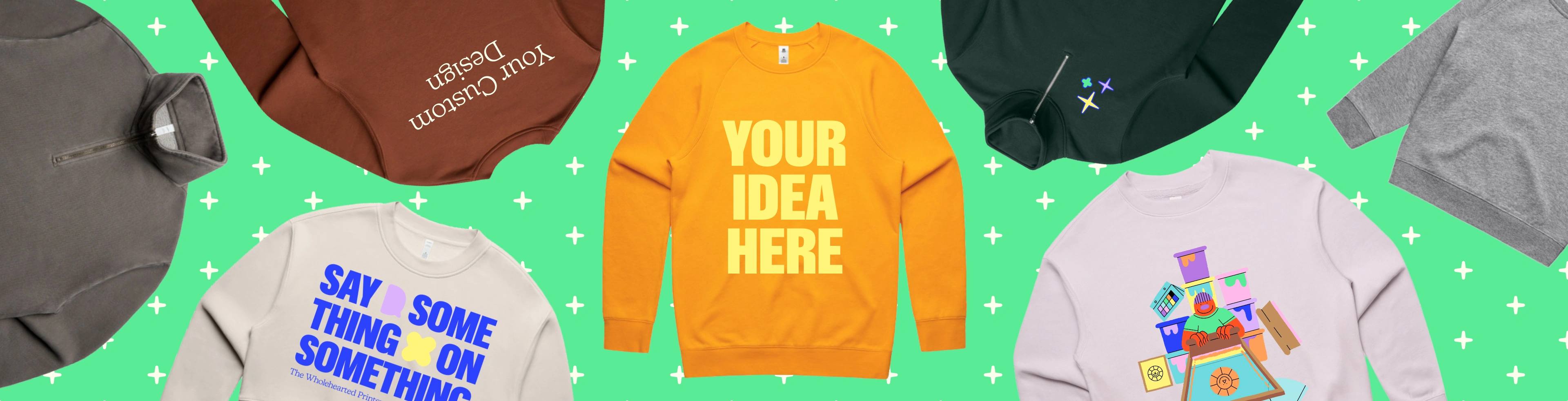 Image with custom printed jumpers and sweaters that have the text "design your own" printed on them