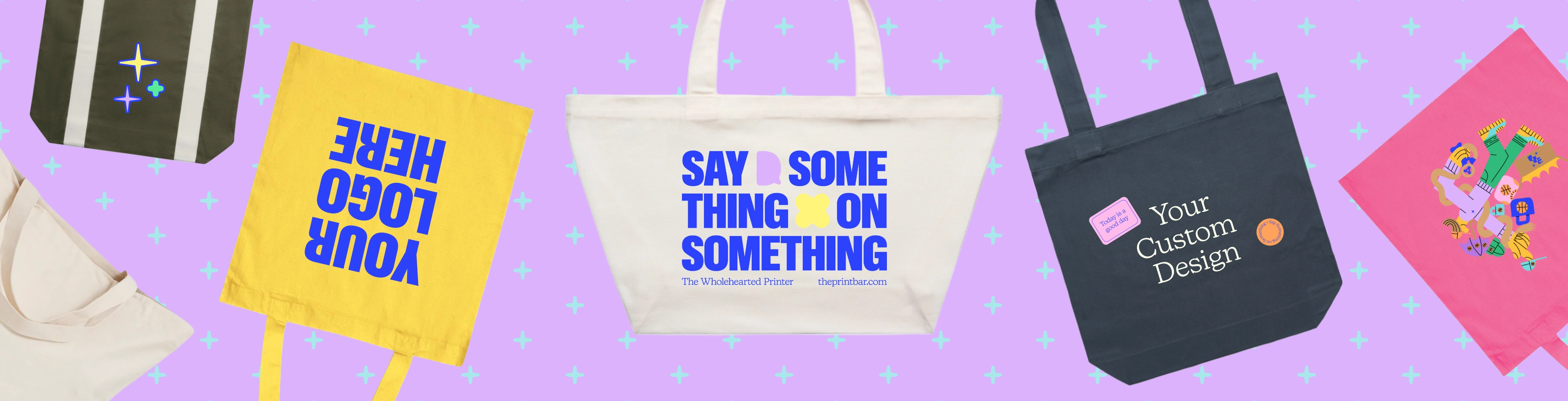 Image with custom printed tote bags that have the text "design your own" printed on them