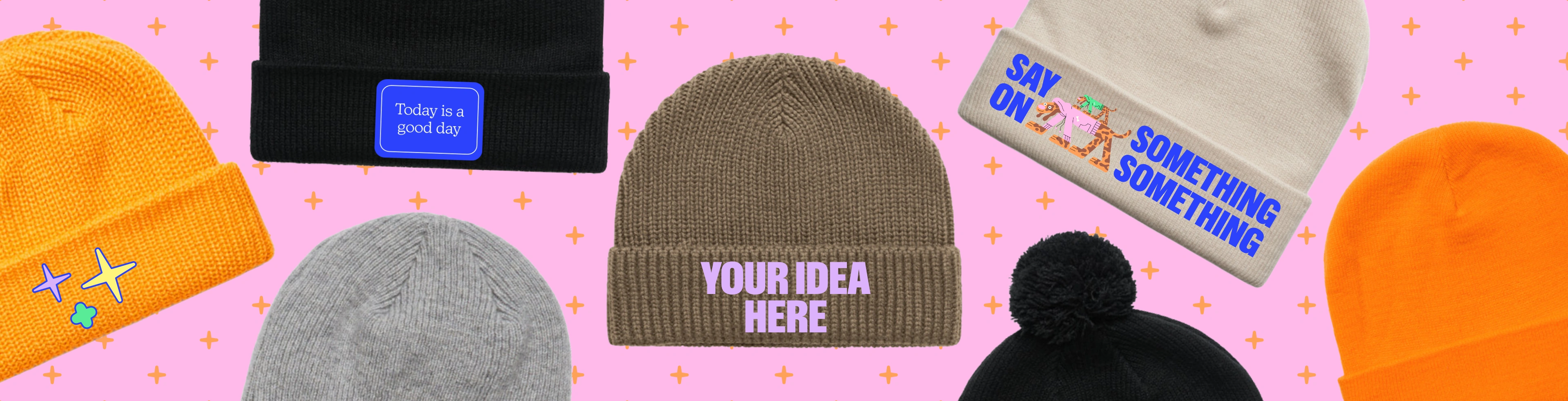 Image with custom beanies that have the text "design your own" embroidered on them